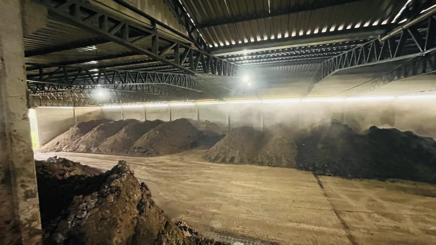 Rows of managed organic material inside the Eco Adubos composting facility