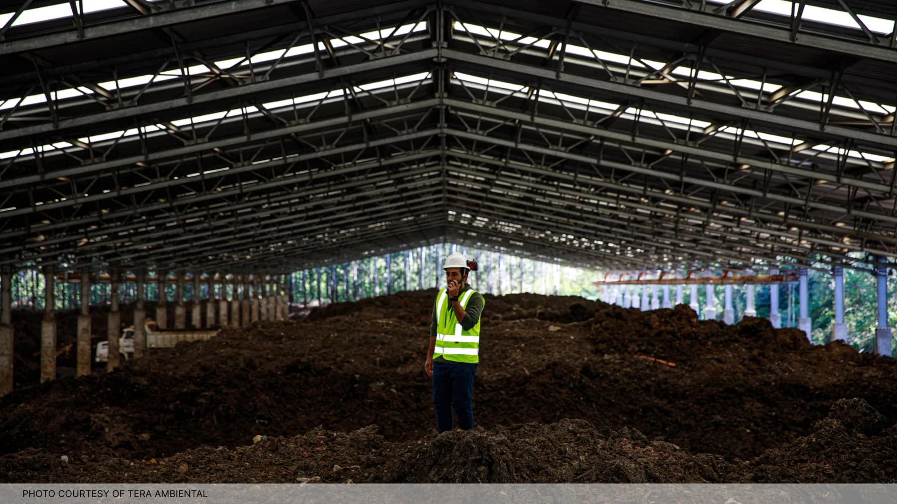 A worker standing inside the biological-treatment facility at Tera Ambiental